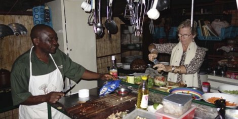 making-Thai-green-fihs-curry-in-the-tented-kitchenin-MAna-Pools,-Zimbabwe